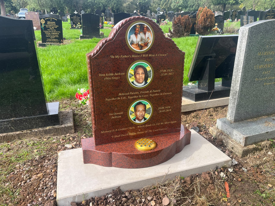 Installed red granite memorial with three circular family portraits