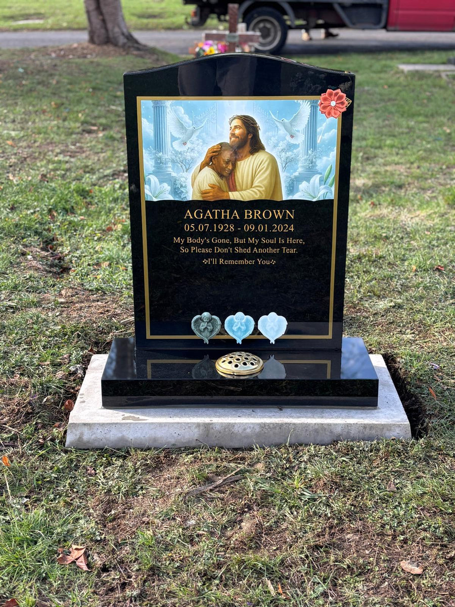 Completed black granite memorial with full colour religious artwork